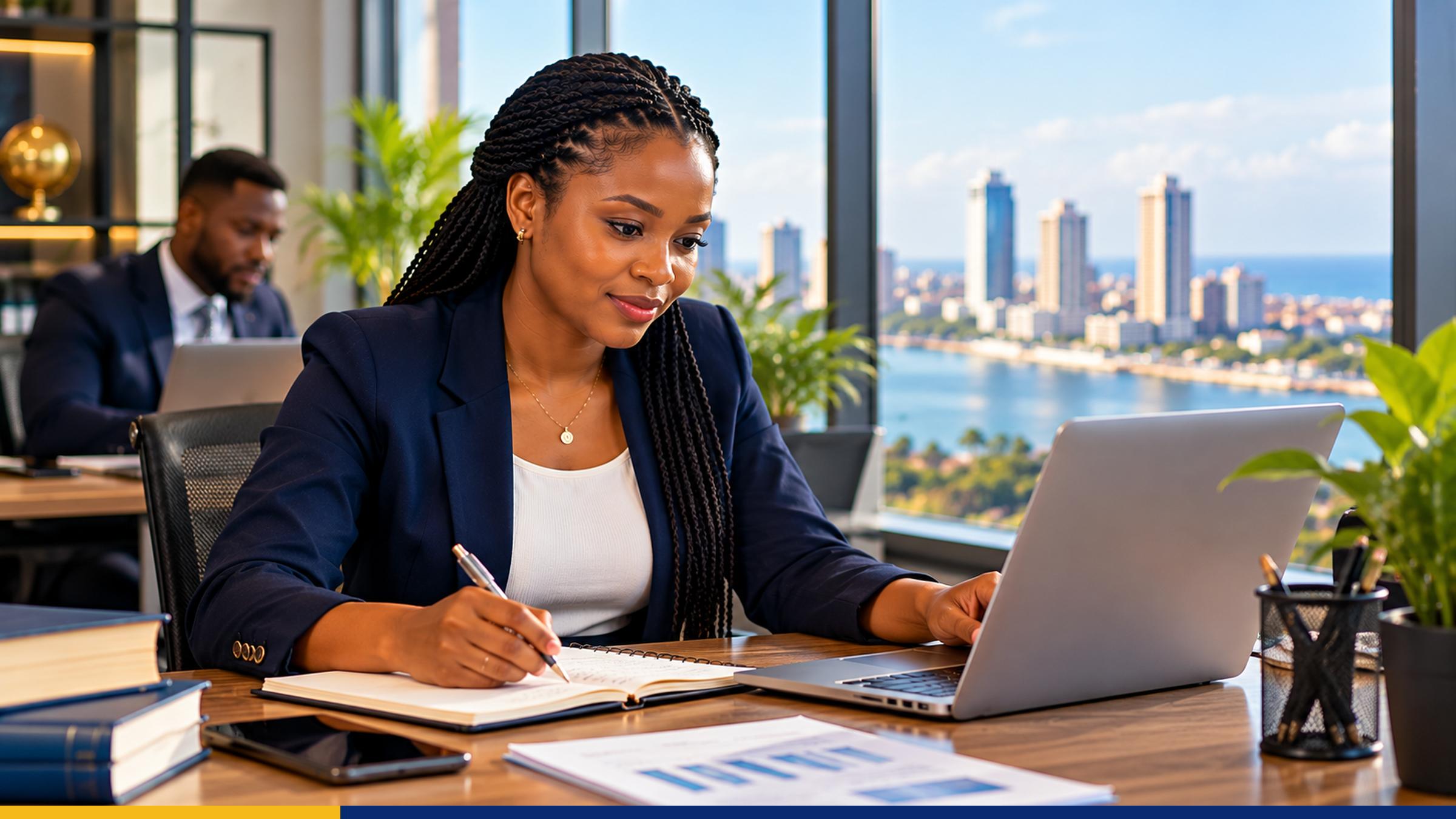Tanzanian young professional practising workplace skills with a laptop and notebook in a modern office